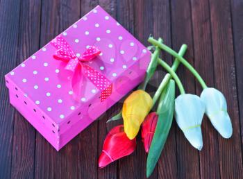 tulipsand box for present on the wooden table, spring flowers