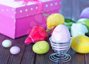 easter background, easter eggs and flowers on a table