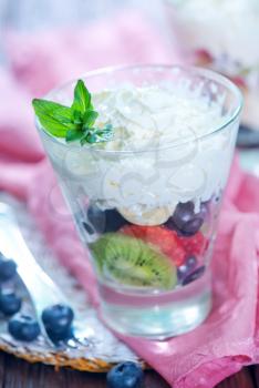 fruit mix with whipped cream in glass