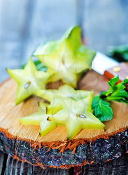carambola on wooden board and on a table