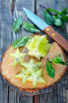 carambola on wooden board and on a table