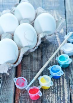 white eggs and paint on a table
