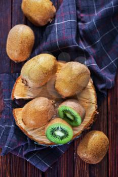 fresh kiwi on wooden board and on a table