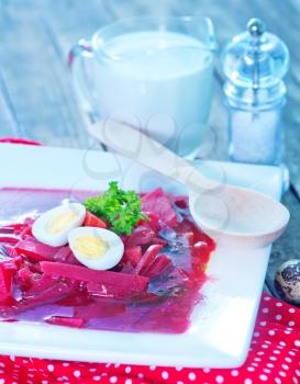 beet soup in bowl and on a table