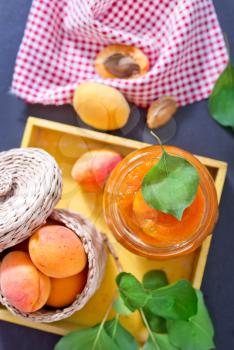 fresh apricot and jam in glass bank on a table