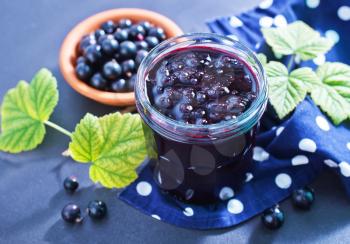 jam in glass bank and fresh black currant