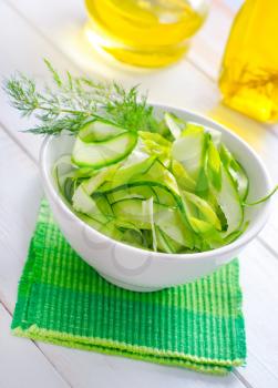 Fresh salad with cucumber and greens in bowl
