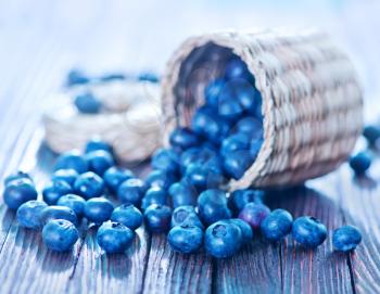 fresh blueberry on the wooden table, blueberry in basket