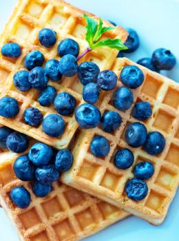 waffle with blueberry on the plate and on a table