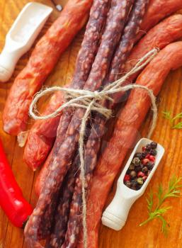 sausages on the wooden table with aroma spice