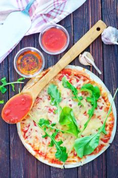 pizza with cheese and fresh tomato on a table