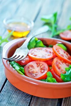 salad with fresh rucola and tomato in bowl