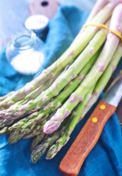 green asparagus, raw asparagus on the wooden table