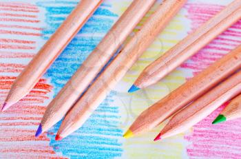 color pencils and paper on the wooden table