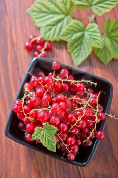 fresh currant in bowl and on a table