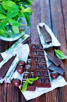 chocolate and mint leaf on the wooden table