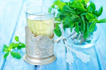 mint tea in glass and on a table