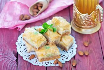 Baklava, Turkish dessert on metal plate and on a table