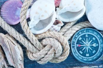 background, sea shells and compass on a table