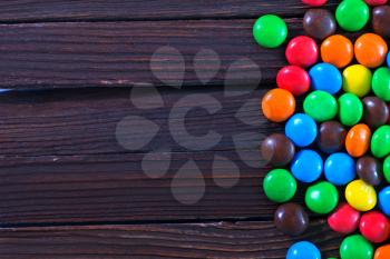 color chocolate candy on the wooden table