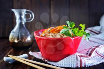 rice noodles with meat and vegetables in bowl
