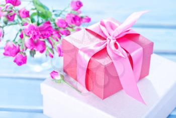 box for present and flowers on a table