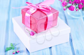 box for present and flowers on a table