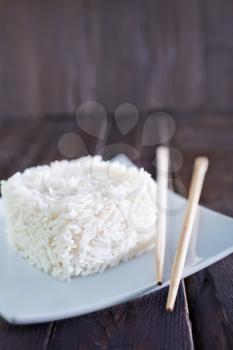 boiled rice on white plate and on a table