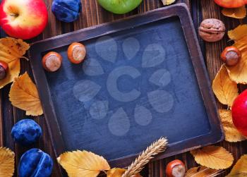 autumn harvest and chalkboard for note on a table