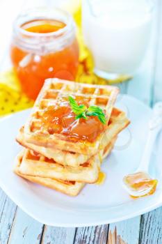 waffles with apricot jam on the plate