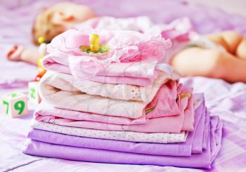 baby clothes on the bed, color baby linen