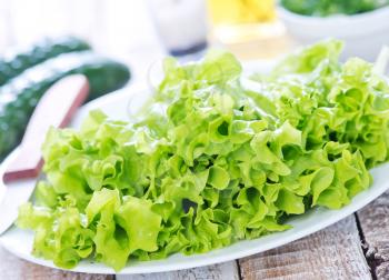 fresh lettuce on plate and on a table