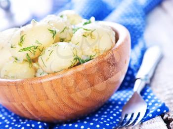 boiled potato in bowl and on a table