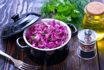 cabbage salad in plack bowl and on a table