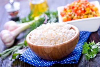 boiled rice with mix vegetables in bowl and on a table