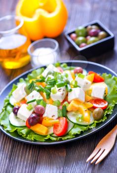 greek salad on plate and on a table