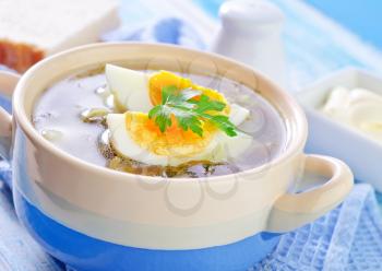 green soup with boiled eggs