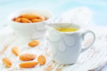almond essential oil and almond in bowl