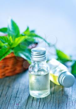 mint oil in bottle and on a table