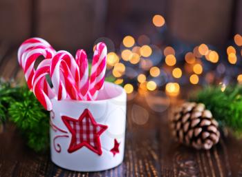 candy canes in white glass and on a table