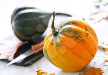 autumn pumpkin on a table, yellow pumpkin