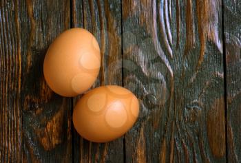raw chicken eggs on the wooden table