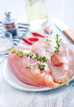 raw chicken fillet with salt and spice on a table