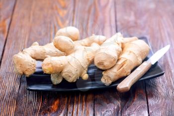 fresh ginger on plate and on a table