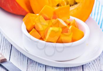 pumpkin in white bowl and on a table