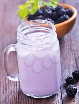 blackberry yogurt in glass and on a table