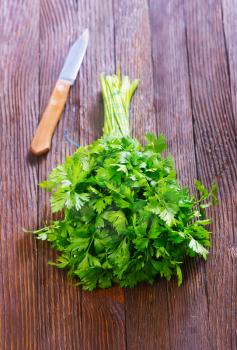 fresh parsley and knife on the wooden table