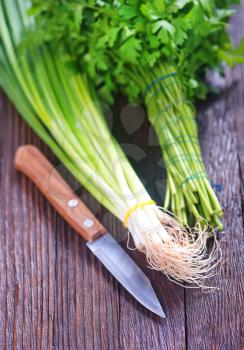parsley and onion on the wooden table