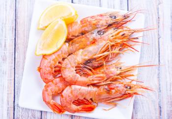 boiled shrimps on plate and on a table