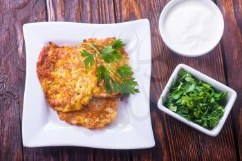 vegetable pancakes on plate and on a table